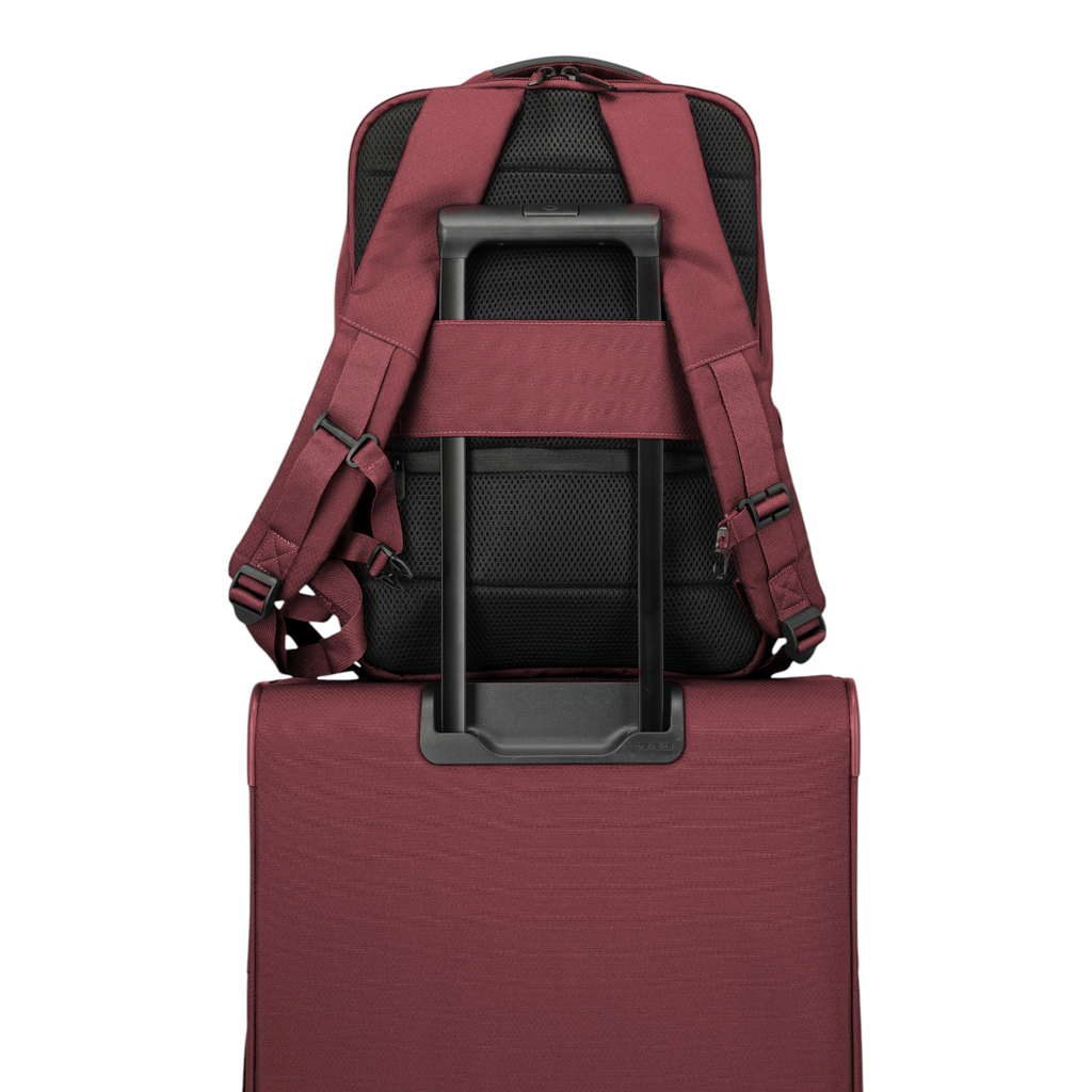 Lieblingstasche Skaii Rucksack M in burgundy attached to a matching suitcase handle with padded back and straps