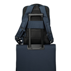 Lieblingstasche Skaii Rucksack M in navy blue, shown attached to a suitcase handle with padded back straps