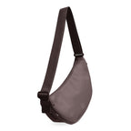 Lieblingstasche small brown crescent-shaped moon bag with an adjustable shoulder strap against a black background