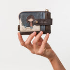 Lieblingstasche small purse featuring Anekke character embroidery, blue and brown faux leather with snap closure.