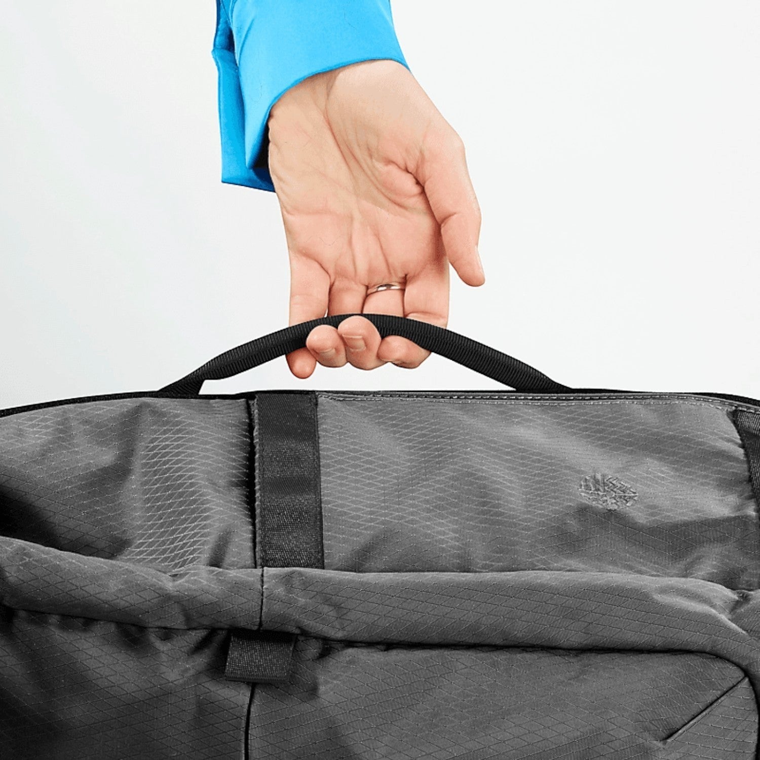 Lieblingstasche Tall41 grey rolltop travel backpack with durable grid pattern fabric held by a top handle