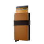 Lieblingstasche Bandwallet Matte in tan leather with a black elastic strap and card holder mechanism