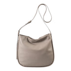 Lieblingstasche Coral taupe leather hobo shoulder bag with an adjustable strap against a white background