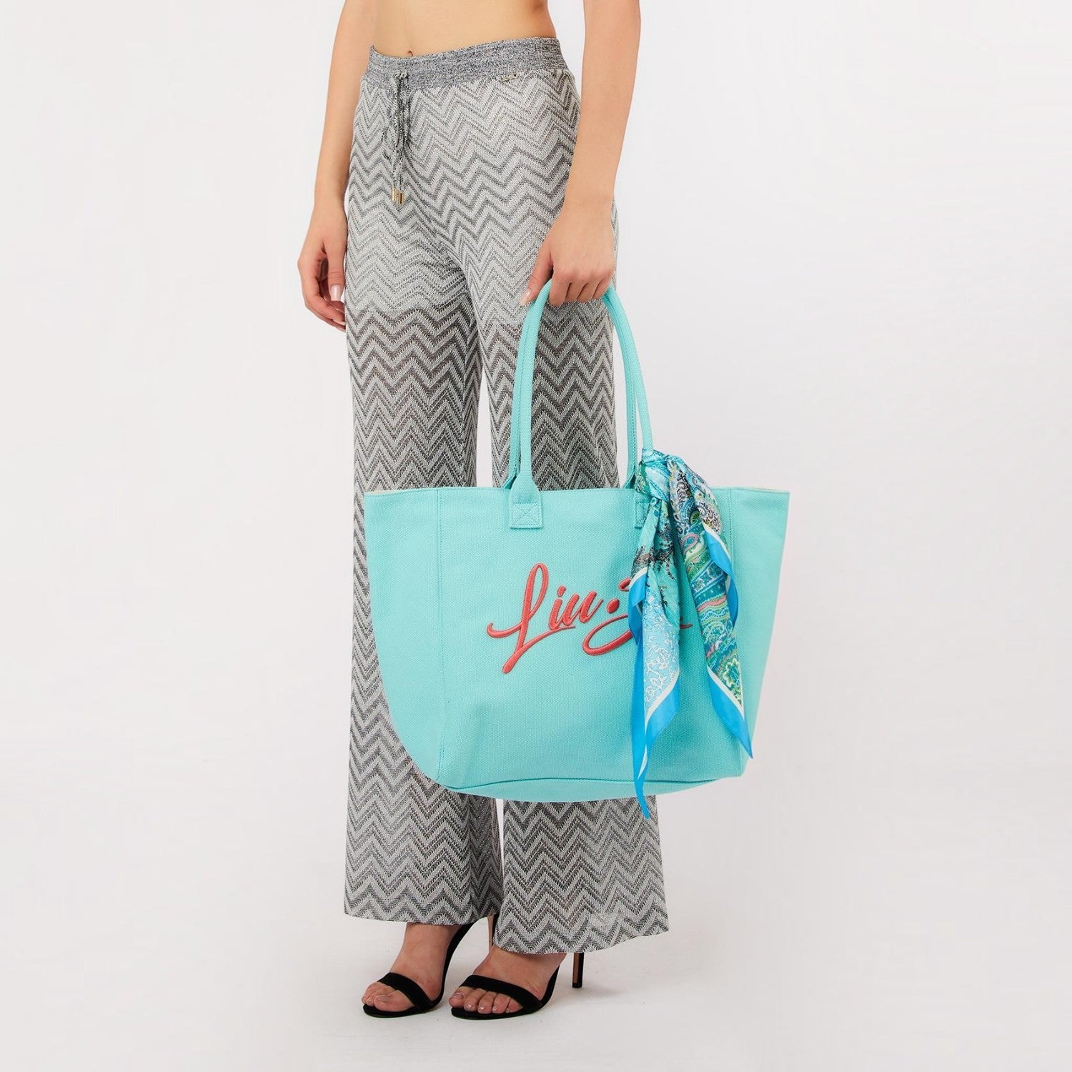 Lieblingstasche Tote L in light blue textured fabric with red logo embroidery and a decorative patterned scarf
