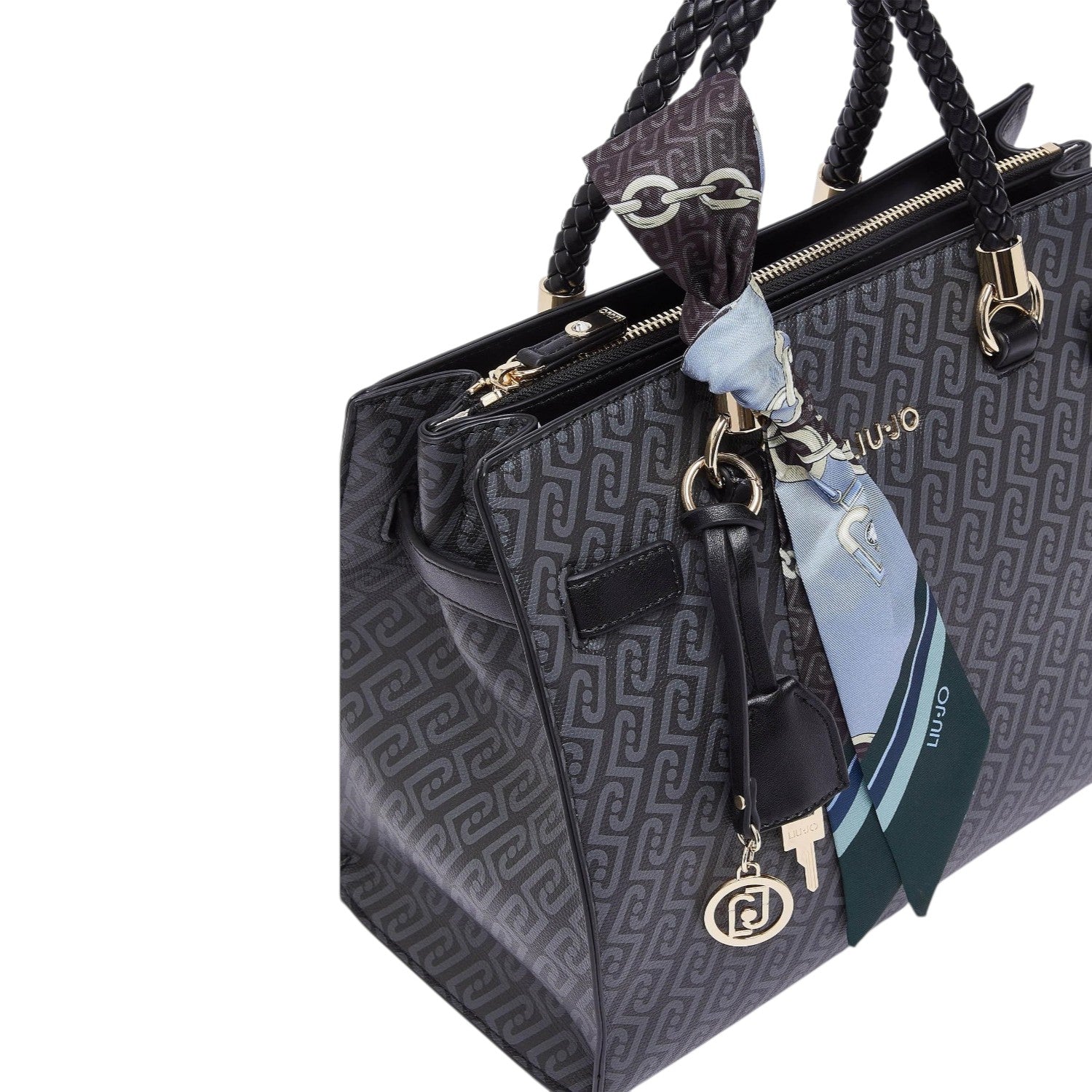 Lieblingstasche Tote M handbag in black with a patterned logo print, braided handles, and a decorative silk scarf.