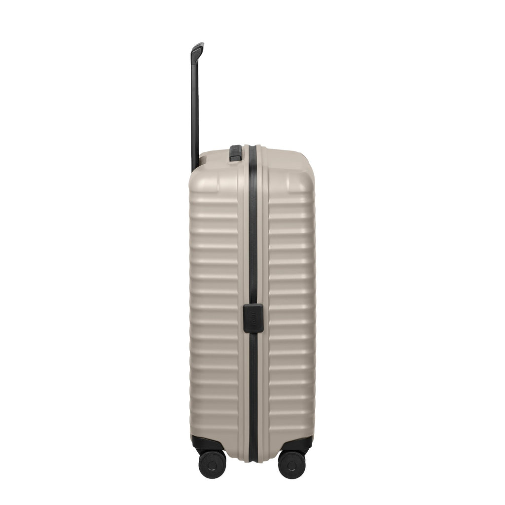 Lieblingstasche UPGRADE 4w Trolley M+ in beige with a hard shell, black trim, and retractable handle, side view.