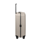 Lieblingstasche UPGRADE 4w Trolley M+ in beige with a hard shell, black trim, and retractable handle, side view.