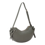 Lieblingstasche Win Re shoulder bag in olive green faux leather with a crescent shape and knot details.